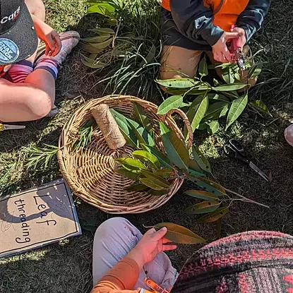 children completing leaf threading activity 